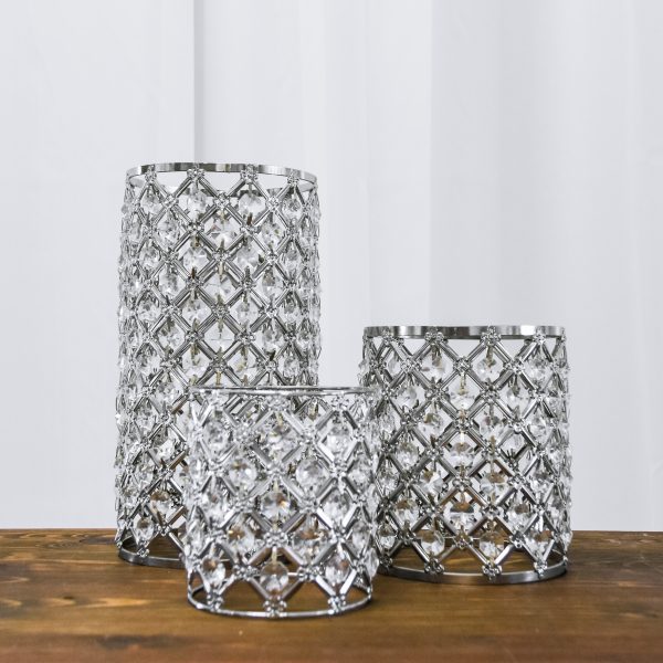 Silver bling trio wedding centerpiece rentals on a wood table.