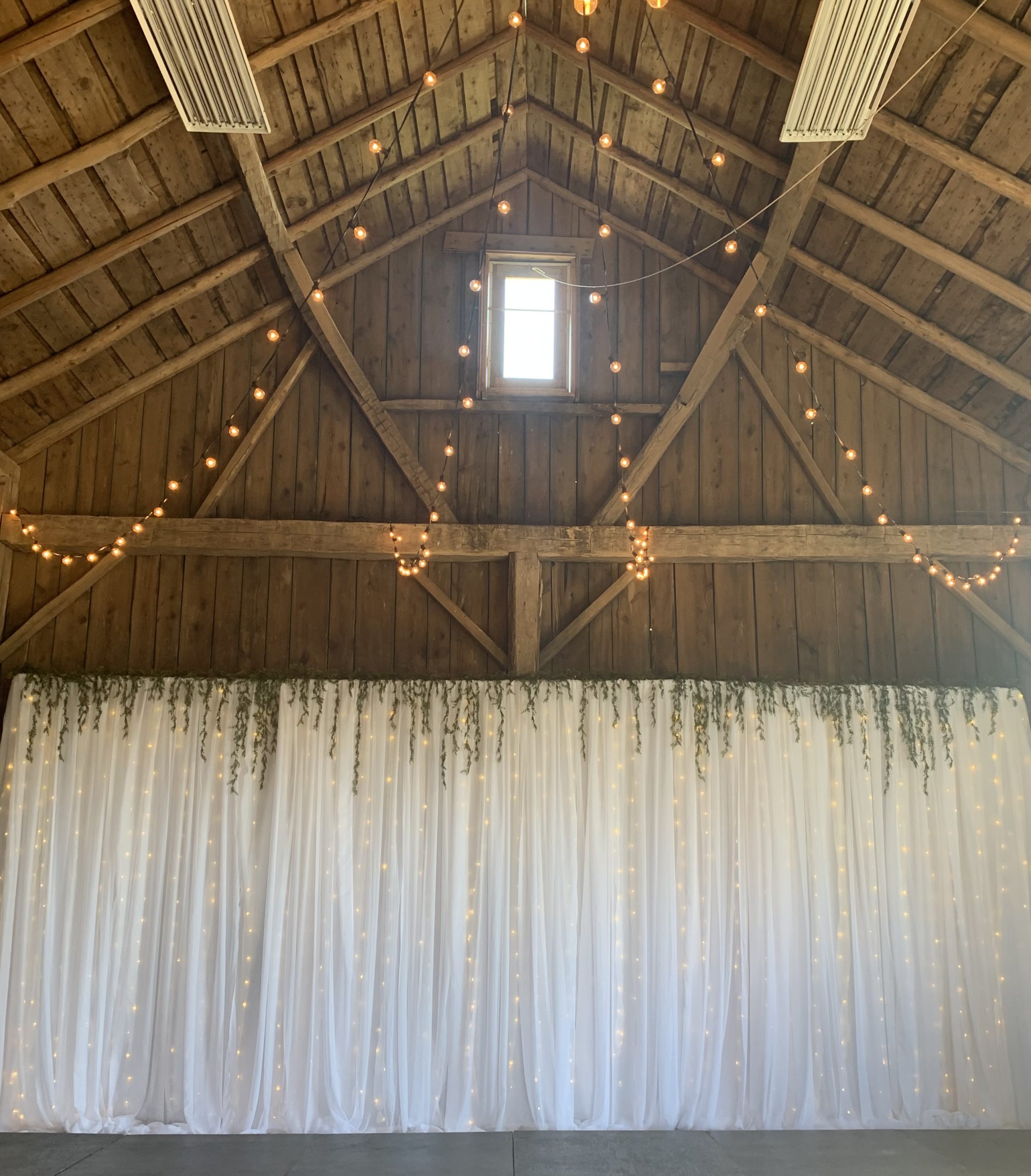 White backdrop used in rustic wedding decor