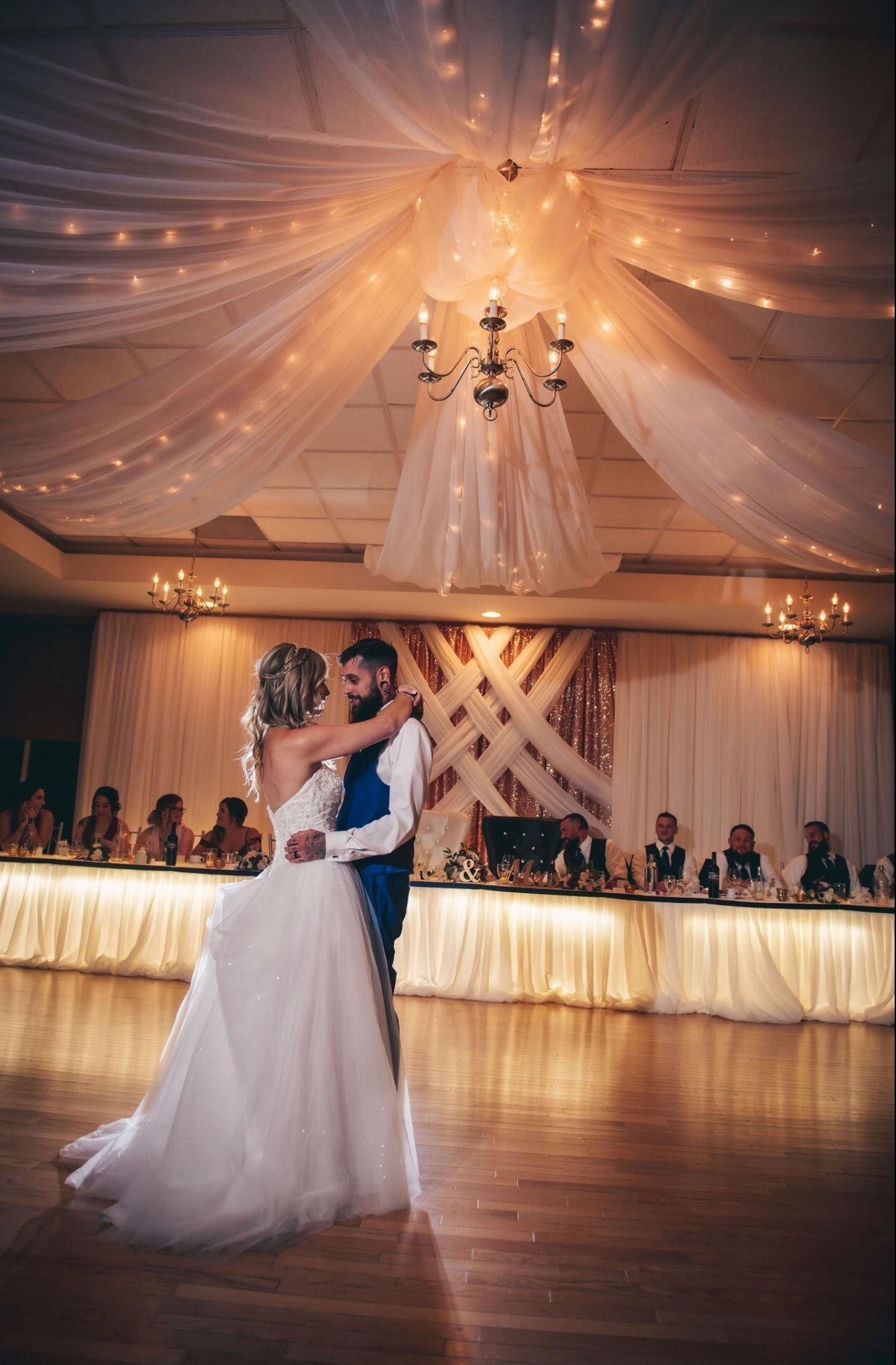 Bride and groom dancing on the dancefloor surrounded by gorgeous wedding decor.