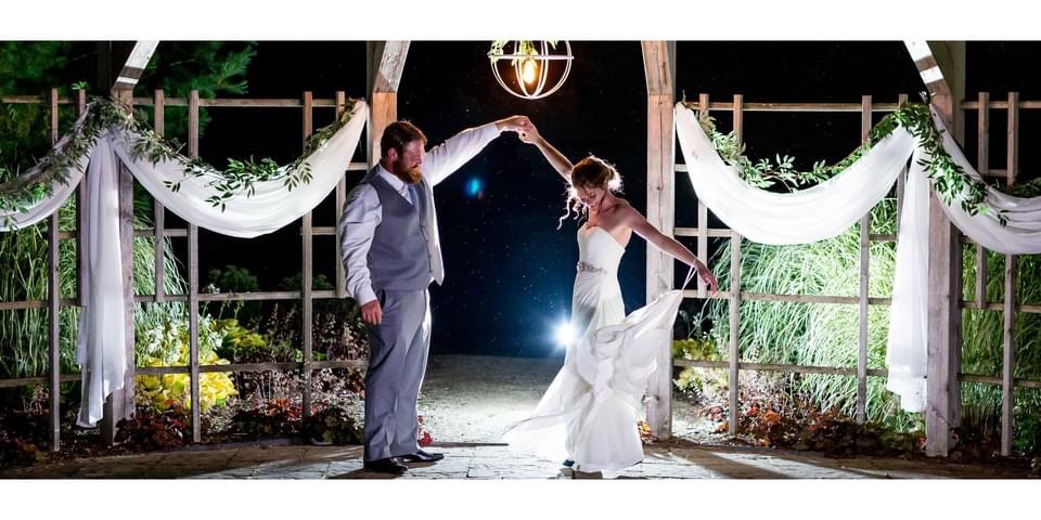 Nighttime wedding illuminated by wedding decor rentals from Devine Wedding Design.