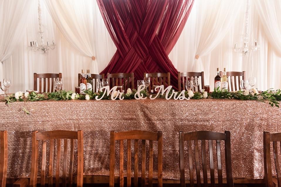 white wedding decor accented in a wine red colour